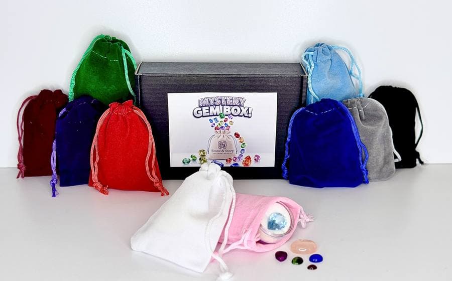 Mystery GemBoxes opened, showing velvet bags and loose stones